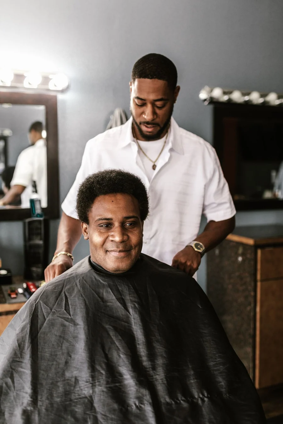 A smiling customer having a haircut in a bright, welcoming barbershop